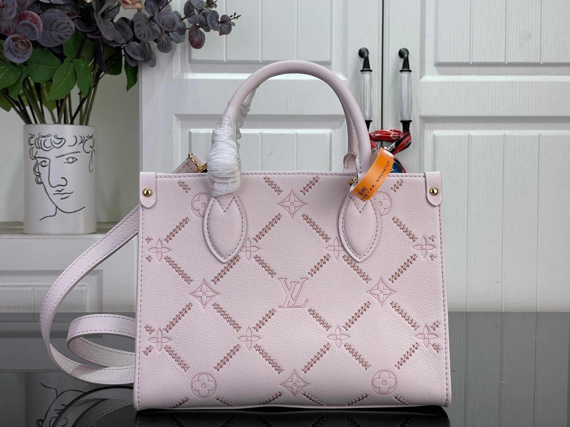Louis Vuitton monogram tote bag in light pink leather with gold hardware and handles