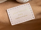 Louis Vuitton bag leather label, embossed logo and stitching on light beige