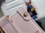 Light pink leather flap closure with gold button and stitched detailing