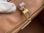 Tan and light pink interior view with gold zipper and small gold toggle at clasp