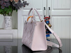 Light pink structured tote bag with top handles, shoulder strap, and gold hardware