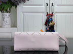 Light pink leather handbag with top flap and gold-tone hardware, plus crossbody strap