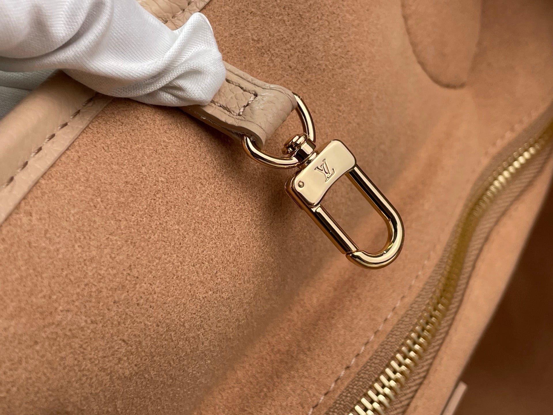 Louis Vuitton taupe tote bag with gold-tone carabiner clip and interior seam