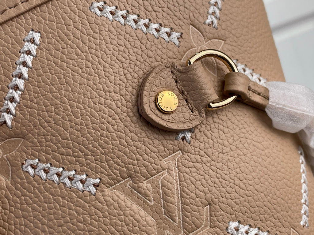Louis Vuitton taupe leather charm and braided trim on textured monogram panel