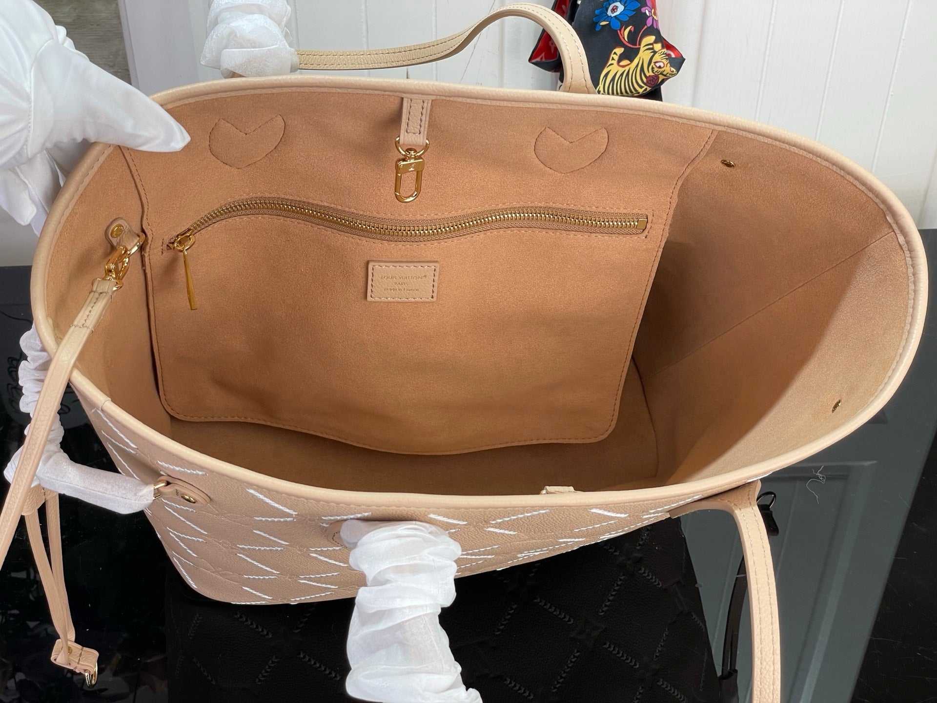 Louis Vuitton taupe interior view of tote bag with front pocket and zipper top
