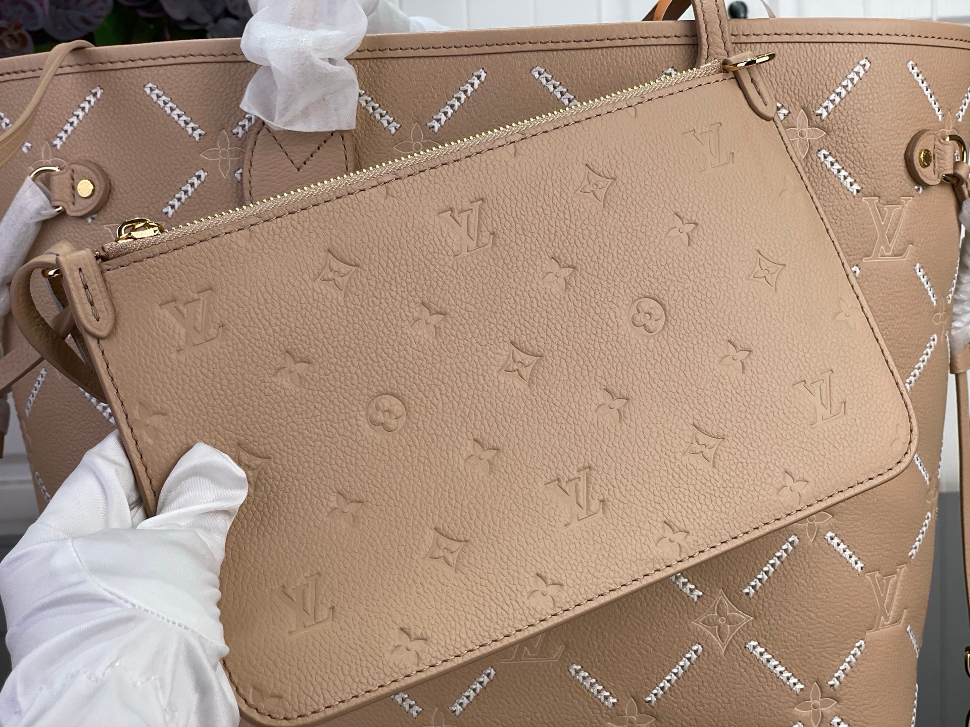 Louis Vuitton monogram bag in beige with front panel and gold-tone zipper hardware