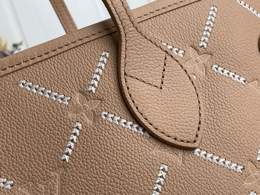 Louis Vuitton taupe leather corner with braided stitching and decorative logo tag