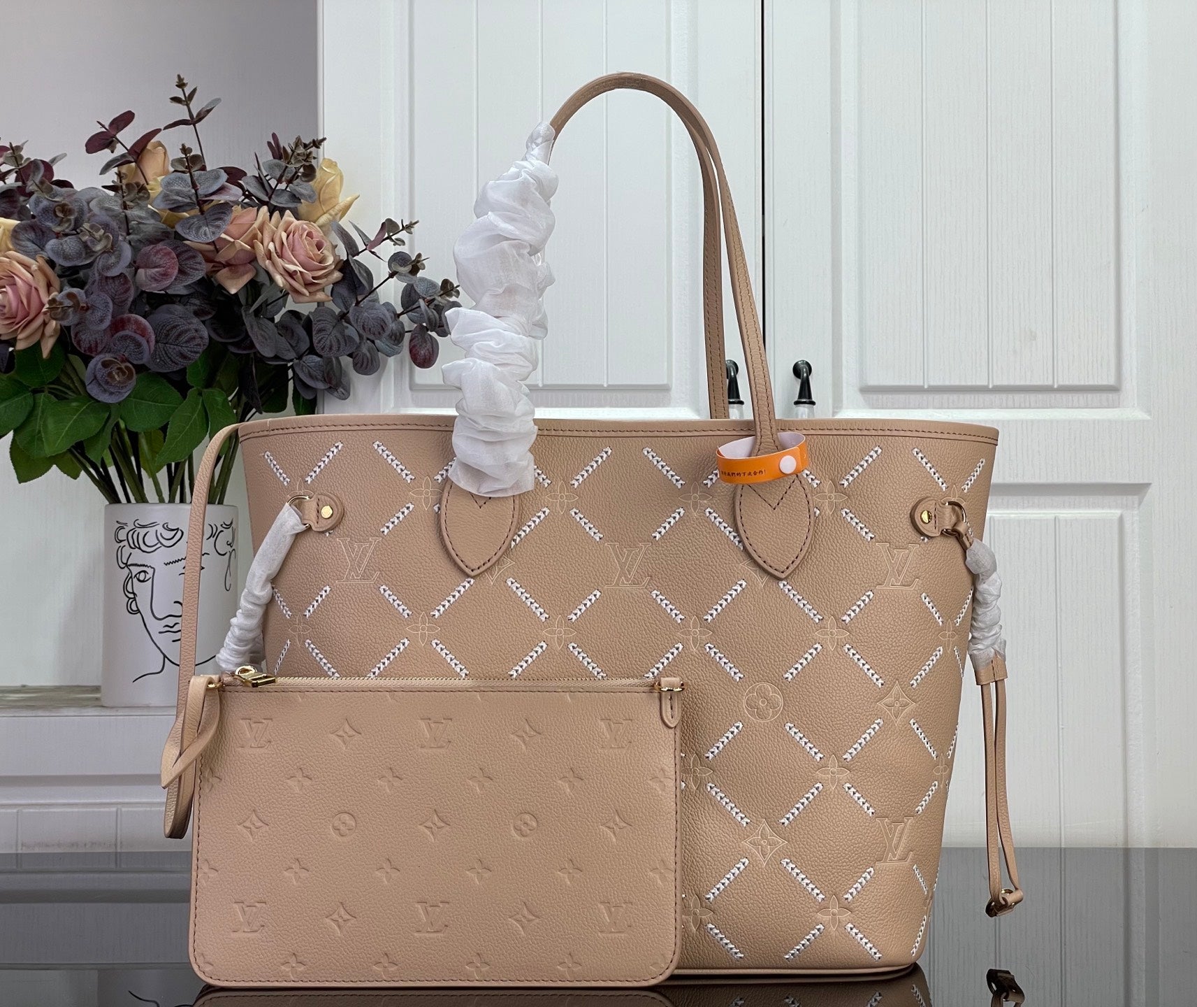 Louis Vuitton taupe monogram tote bag with leather handles and front logo hardware
