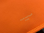 Orange pebbled leather bag with engraved LV logo on the surface