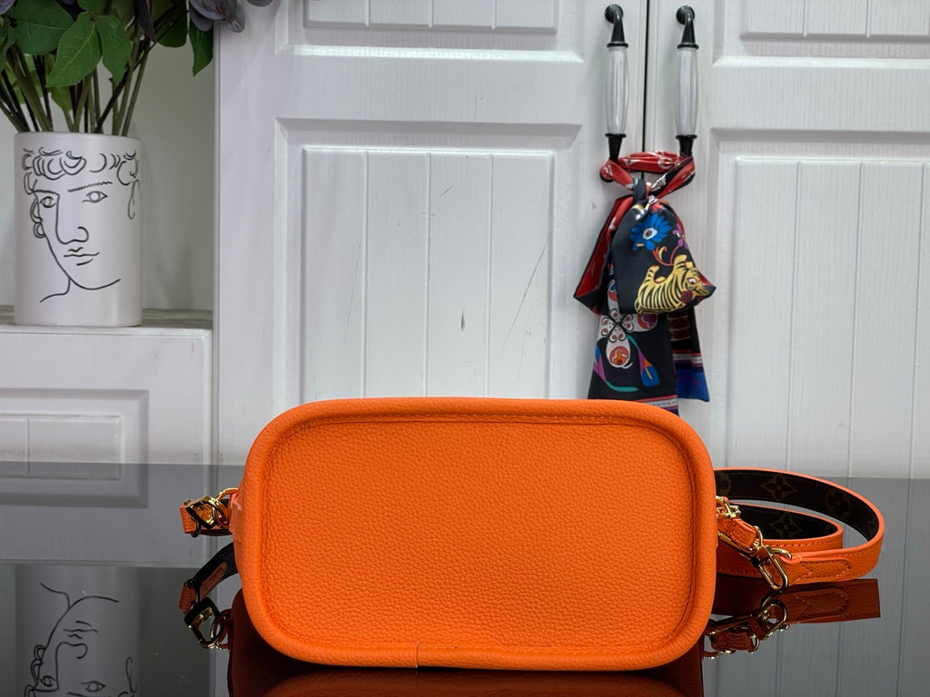 Orange leather-look mini crossbody bag with front flap and adjustable strap