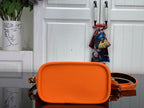 Orange leather-look mini crossbody bag with front flap and adjustable strap