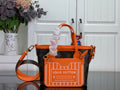 Louis Vuitton monogram tote with orange handles, strap, and logo front pocket