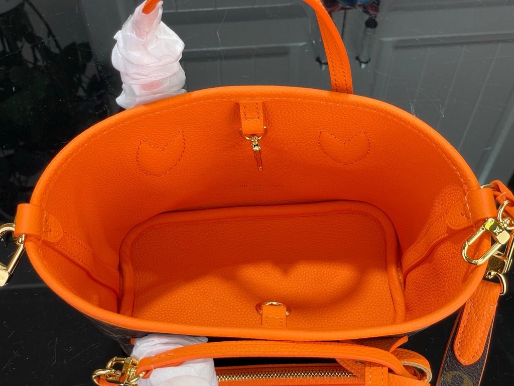 Louis Vuitton orange interior lining with center snap pocket and hanging tag