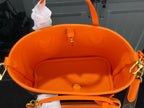 Louis Vuitton orange interior lining with center snap pocket and hanging tag