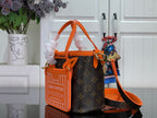 Louis Vuitton monogram handbag with orange mini pouch-style front and crossbody strap