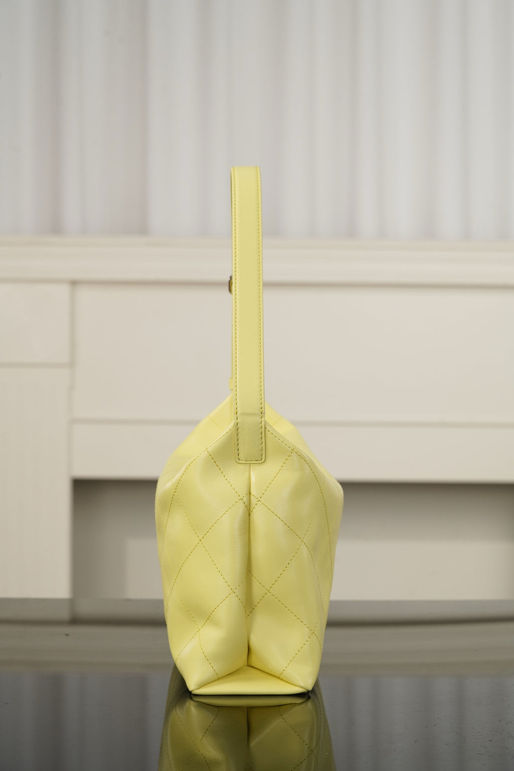 Chanel bag in light yellow leather with vertical strap and diamond-quilted body, gold hardware