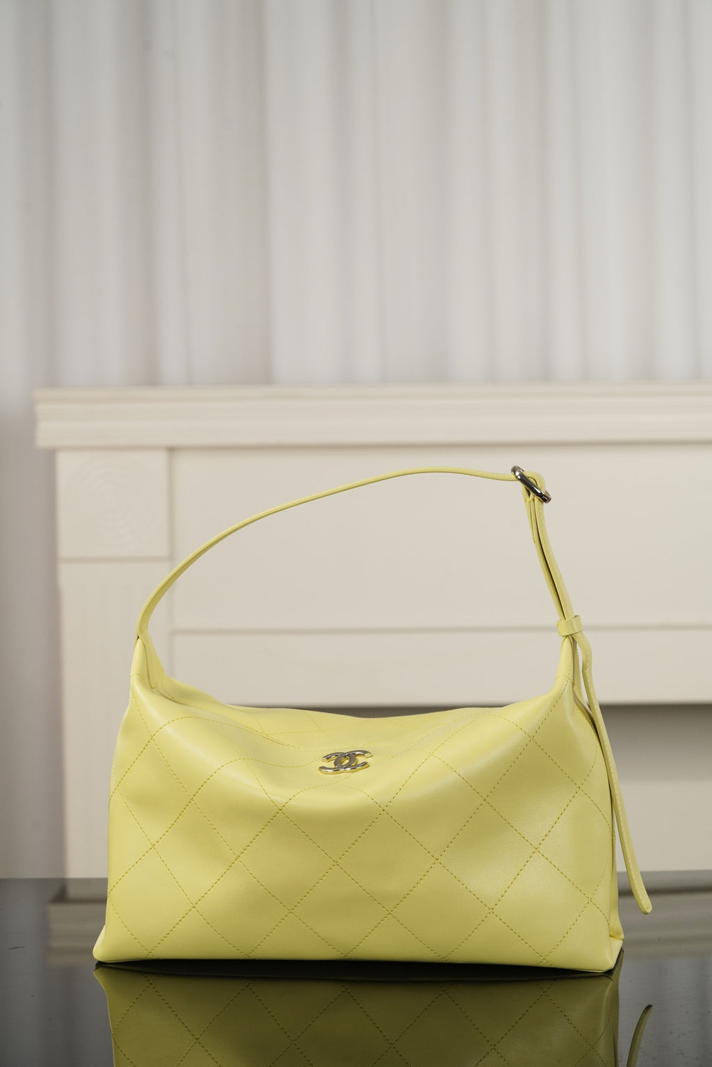 Chanel hobo bag in light yellow leather with top handle and slouchy silhouette, gold-tone hardware