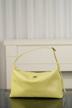 Chanel hobo bag in light yellow leather with top handle and slouchy silhouette, gold-tone hardware