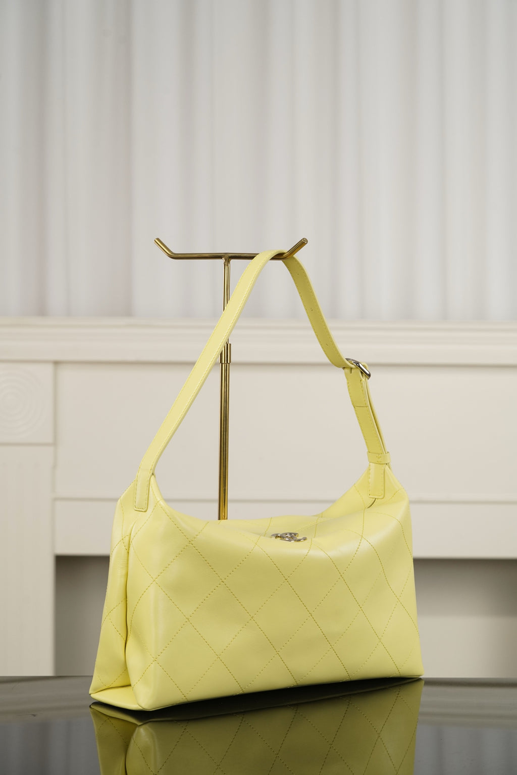 Chanel hobo bag in light yellow with diamond-quilted body, curved handle, gold hardware