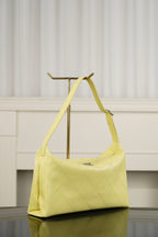 Chanel hobo bag in light yellow with diamond-quilted body, curved handle, gold hardware
