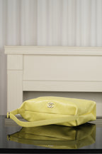 Chanel hobo bag in light yellow leather with diamond quilting and top handle, gold-tone details