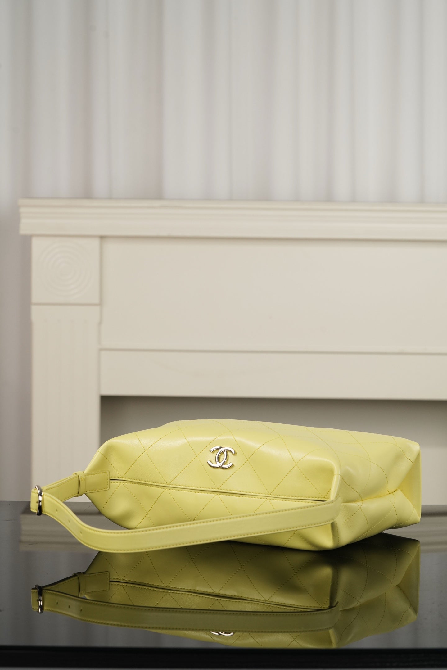Chanel hobo bag in light yellow leather with diamond quilting and top handle, gold-tone details