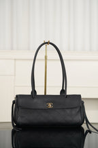 Chanel handbag in dark textured leather, top handle, flap with gold logo, crossbody strap