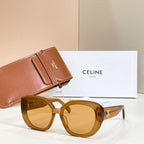 Amber round sunglasses with tinted lenses and gold-tone logo on arms