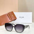 Black round sunglasses with dark lenses and gold logo detail on arms