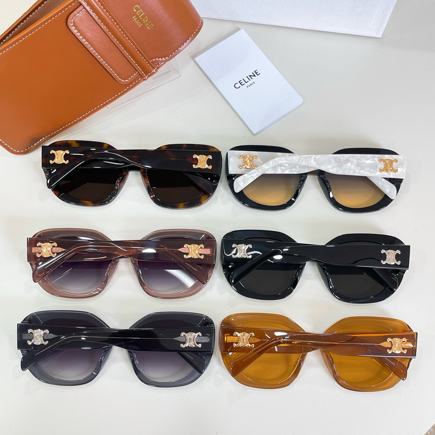 Set of round sunglasses with patterned frames in black, brown, and amber