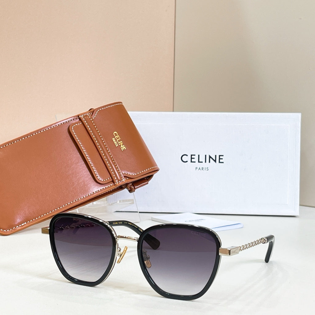 Black cat-eye sunglasses with dark lenses and gold chain temples