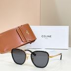 Black cat-eye sunglasses with dark lenses and gold chain temples
