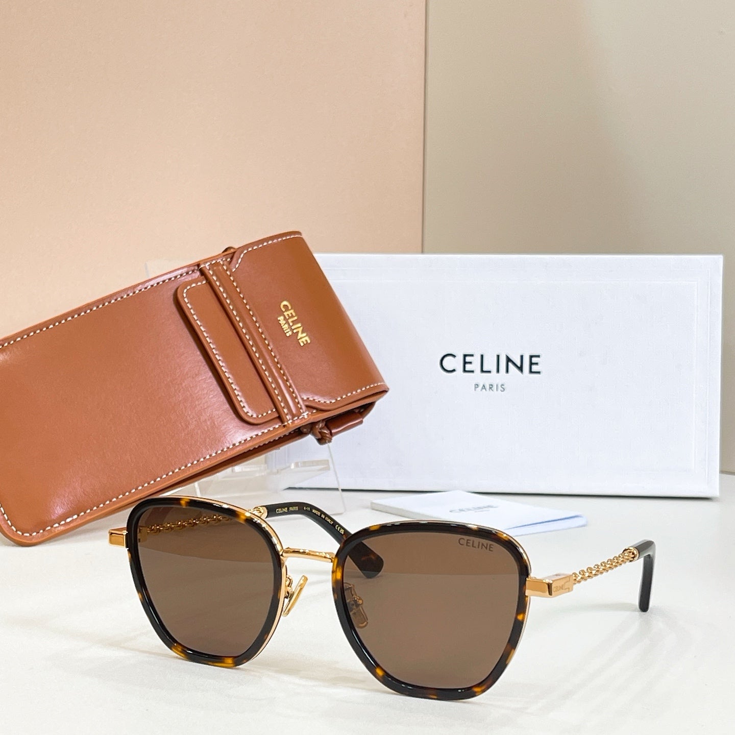 Tortoise-look sunglasses with amber lenses and gold chain temples