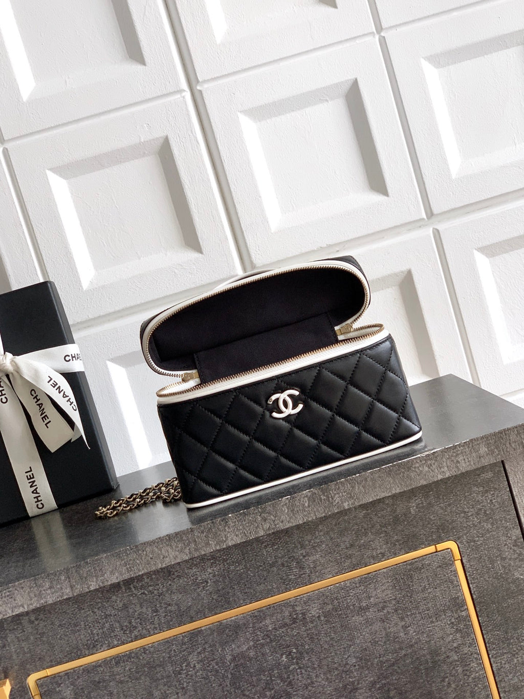 Black quilted mini handbag with open top, showing interior, chain strap