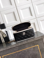 Black quilted mini handbag with open top, showing interior, chain strap