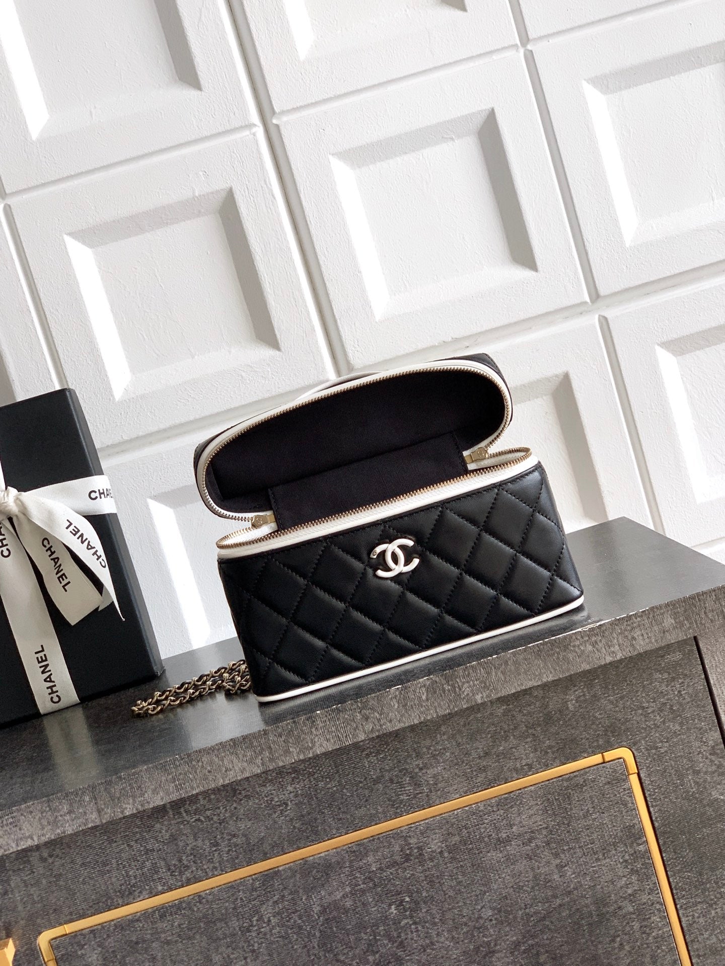 Black quilted mini handbag with open top, showing interior, chain strap