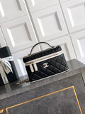 Black quilted mini handbag with chain strap and top handle, gold-tone trim