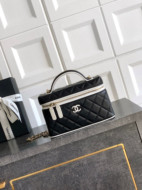 Black quilted mini handbag with chain strap and top handle, gold-tone trim