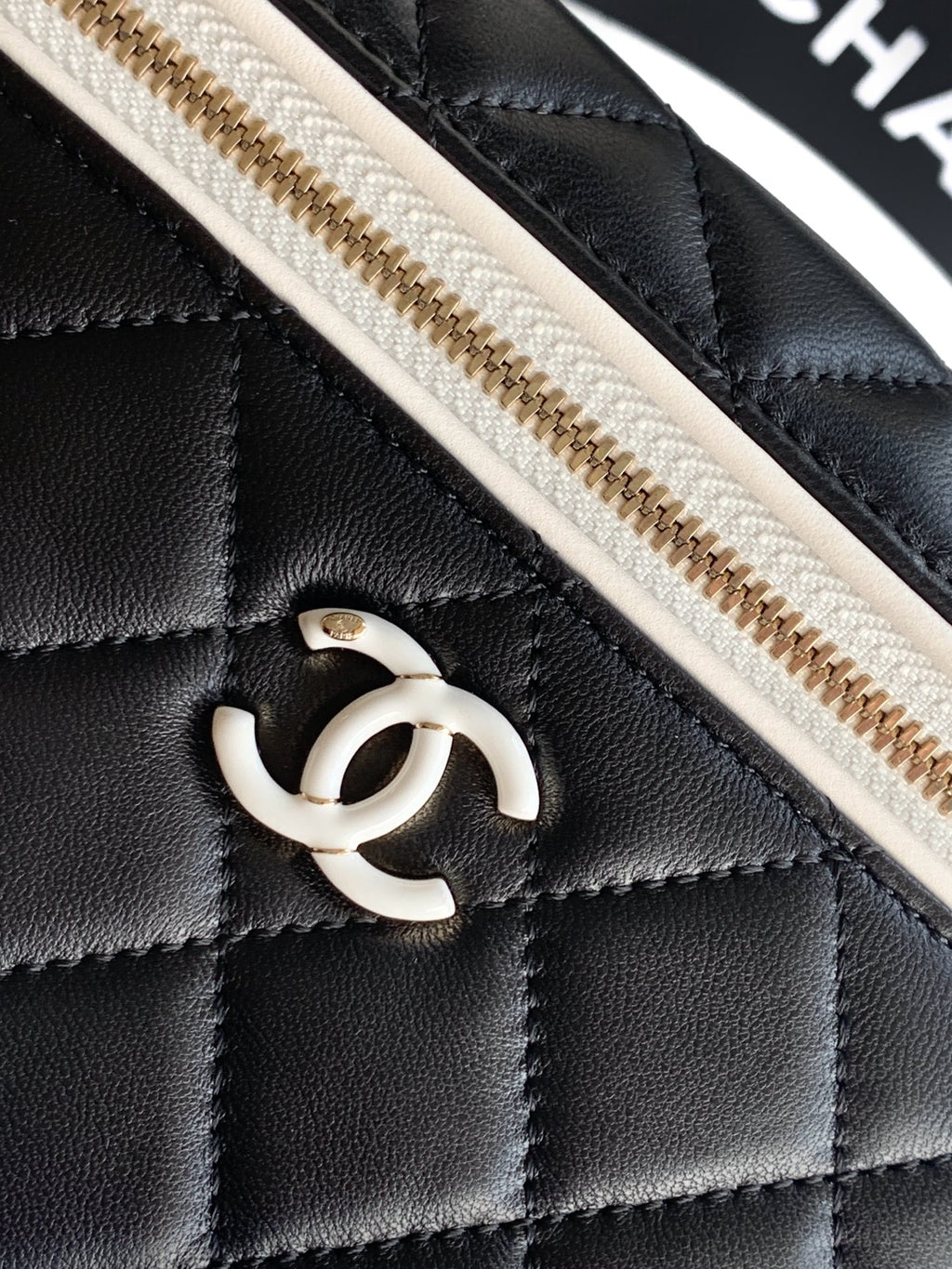 CC logo on black quilted leather with gold-tone zipper detail