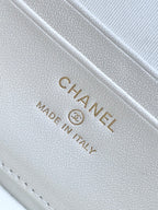 Chanel logo stamp on white quilted leather, text reads "Made in Italy"
