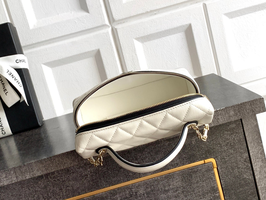 Cream quilted mini bag with rounded top and chain handle, gold-tone zipper