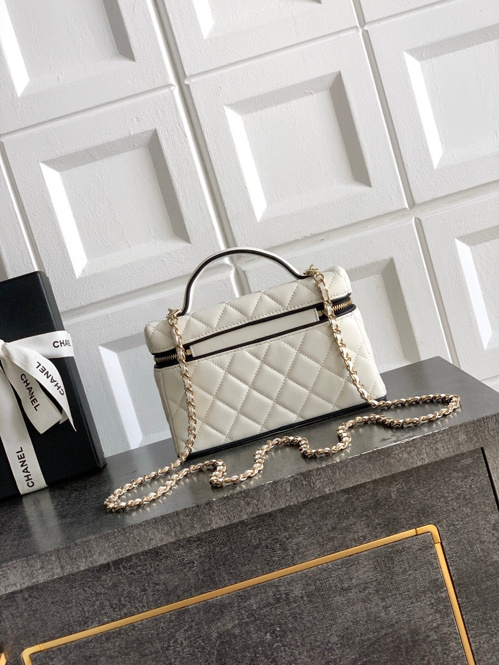 Quilted handbag with curved top handle, chain shoulder strap, white with gold hardware