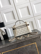 Quilted handbag with curved top handle, chain shoulder strap, white with gold hardware