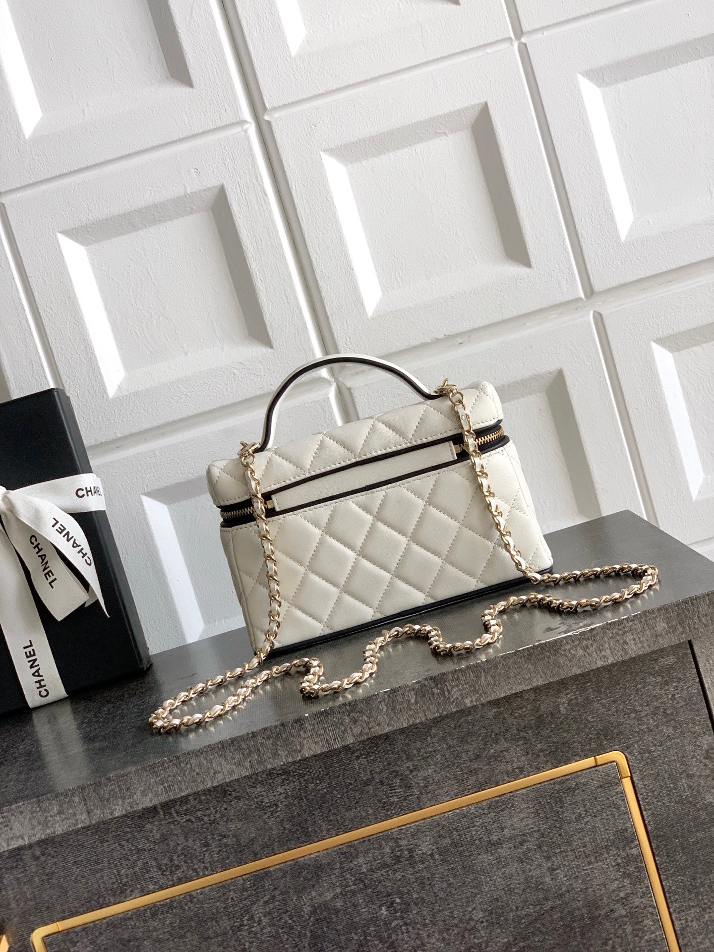 Quilted handbag with curved top handle, chain shoulder strap, white with gold hardware
