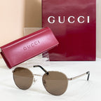 Round gold sunglasses with brown tinted lenses and slim metal temple arms