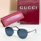 Round gold sunglasses with blue tinted lenses and slender metal temple arms