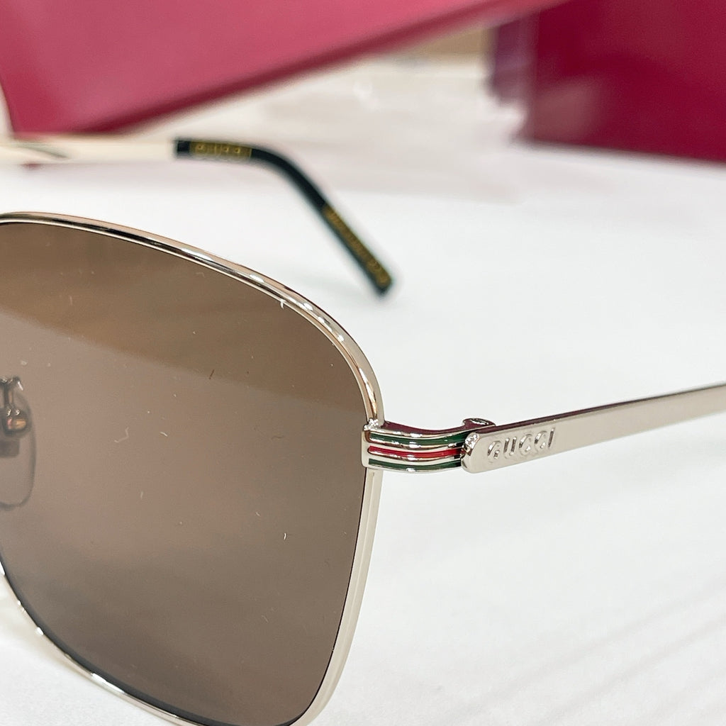 Sunglasses temple and lens close-up with gold logo detail