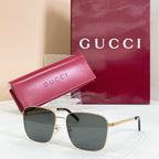 Square sunglasses with gold frame and dark lenses, with pink logo case