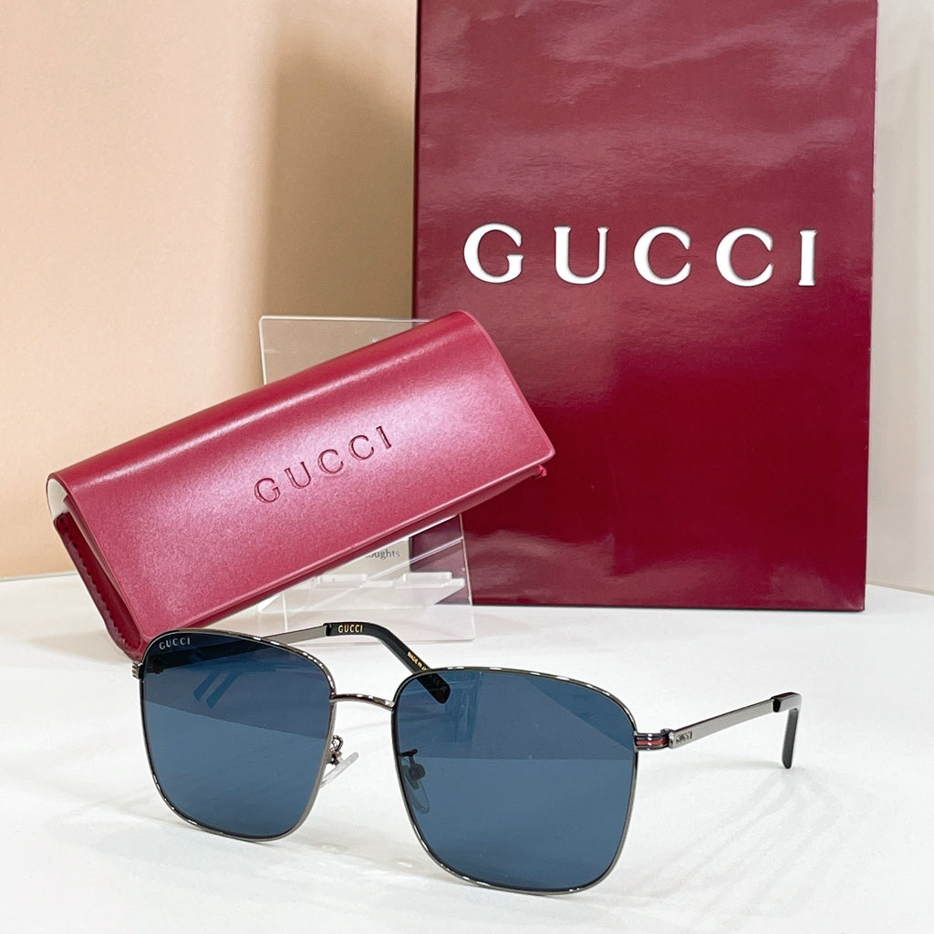 Square sunglasses with silver frame and blue-tinted lenses, with pink logo case