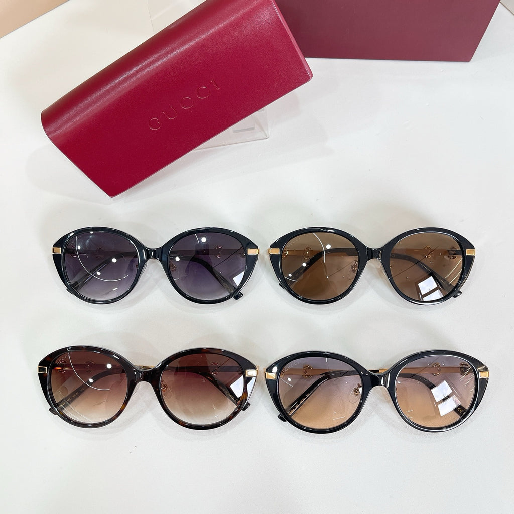 Four round sunglasses with black frames and mixed tinted lenses